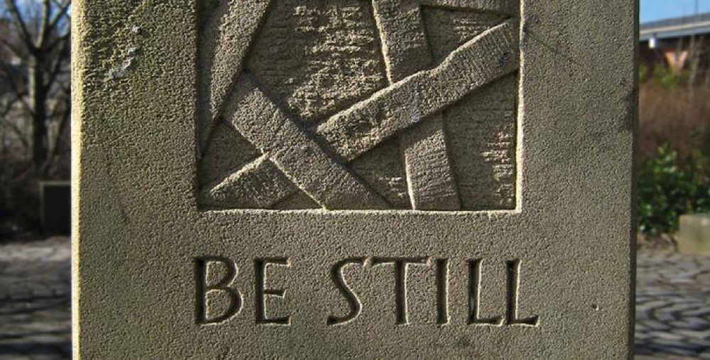 A stone sign that says Be Still
