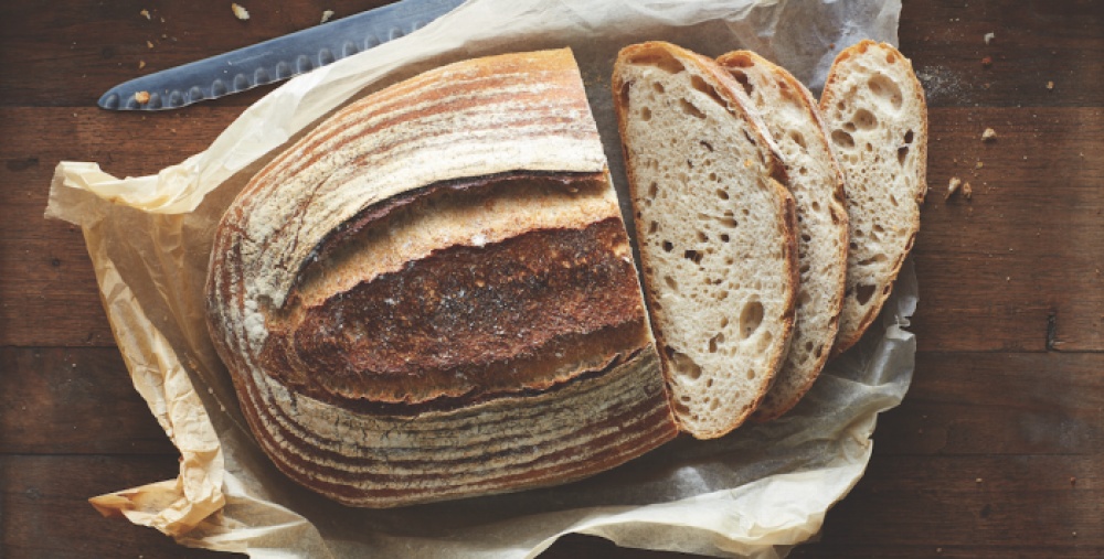 Loaf of bread with three slices cut