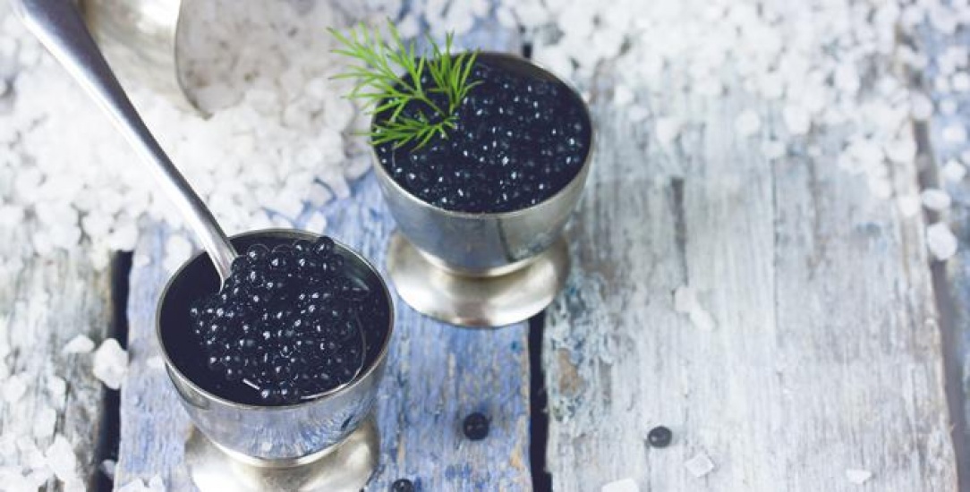 Black Caviar in silver pots with a spoon in