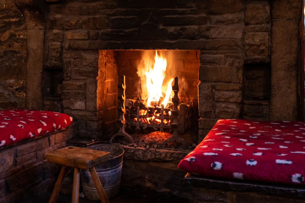 open fire in a cottage type pub with bar stool