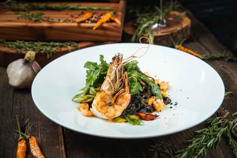 Italian cuisine dish shrimp and arugula spaghetti with ink cuttlefish