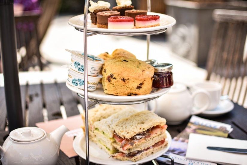 Afternoon tea with dessert and scones served on a beautiful tray