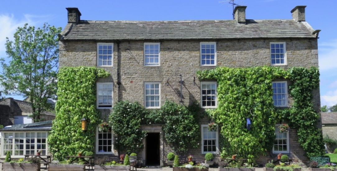 A pub with green ivy on
