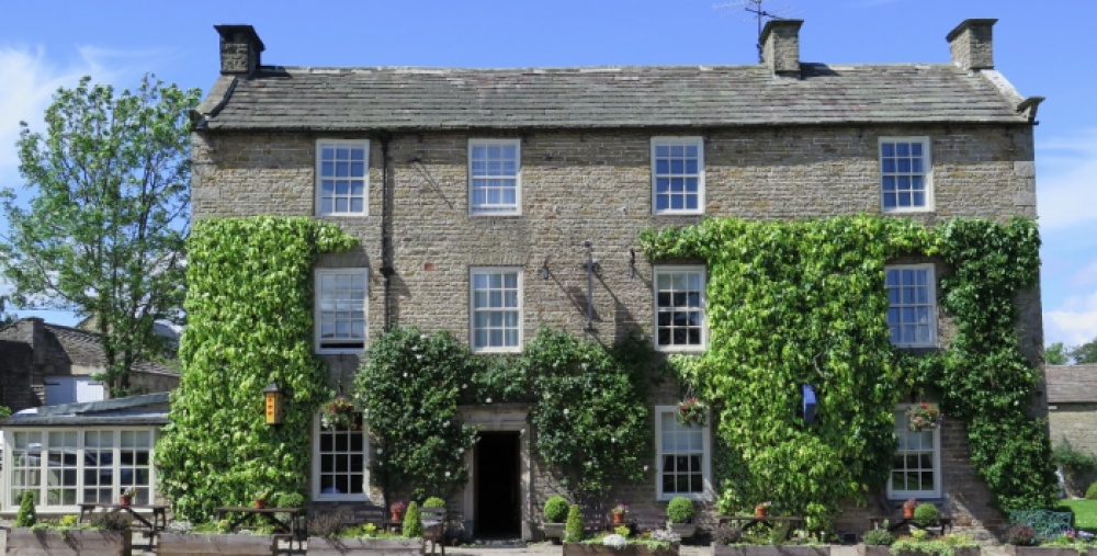 A pub with green ivy on