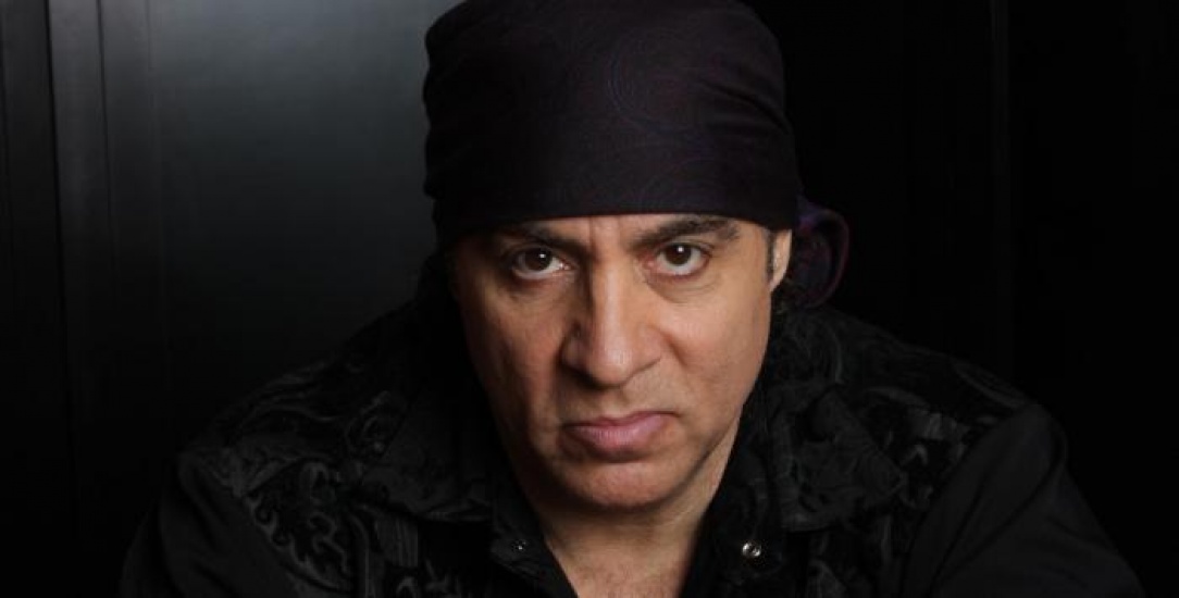 Steve van Zandt wearing all black and a black bandana