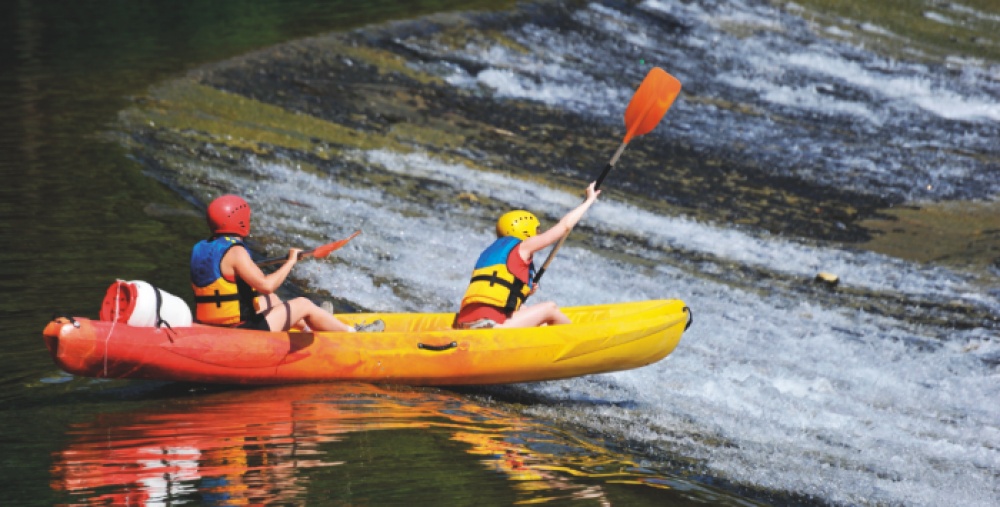 Two people kayaking on a river