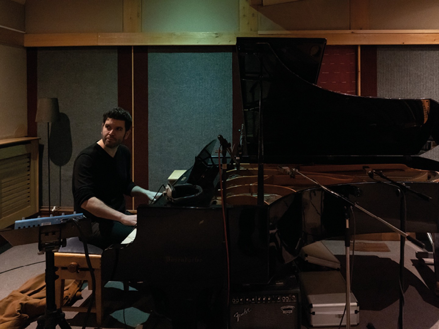 man playing a piano in a studio