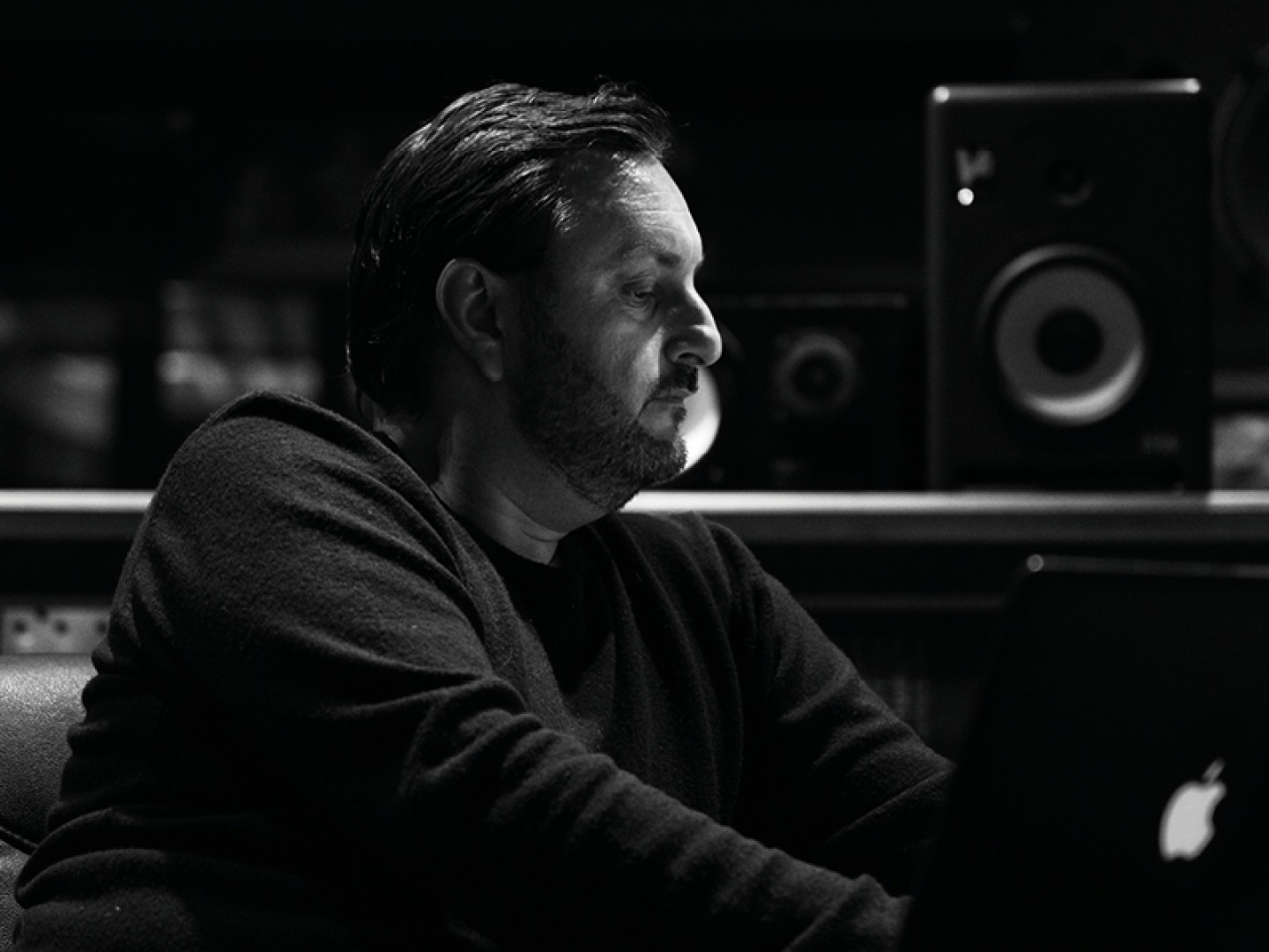 man working on a computer in music studio