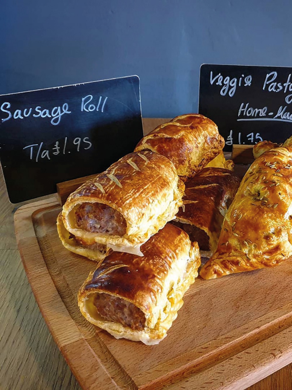 Sausage rolls and pastas on a wooden board