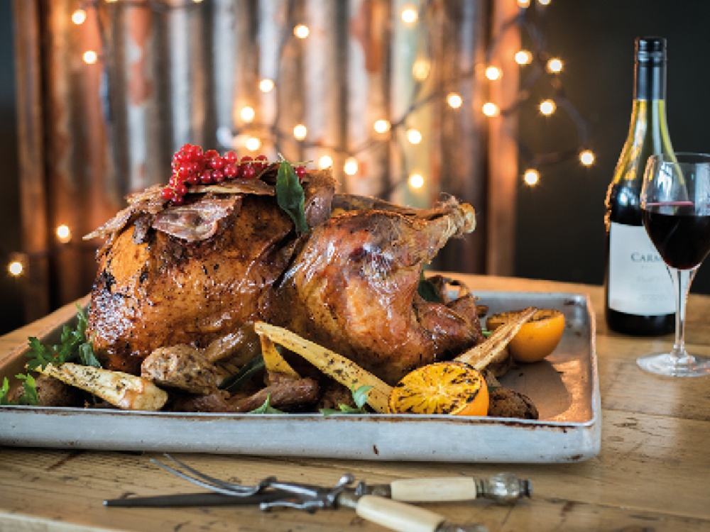 Christmas Roast in baking tray with a glass of red wine