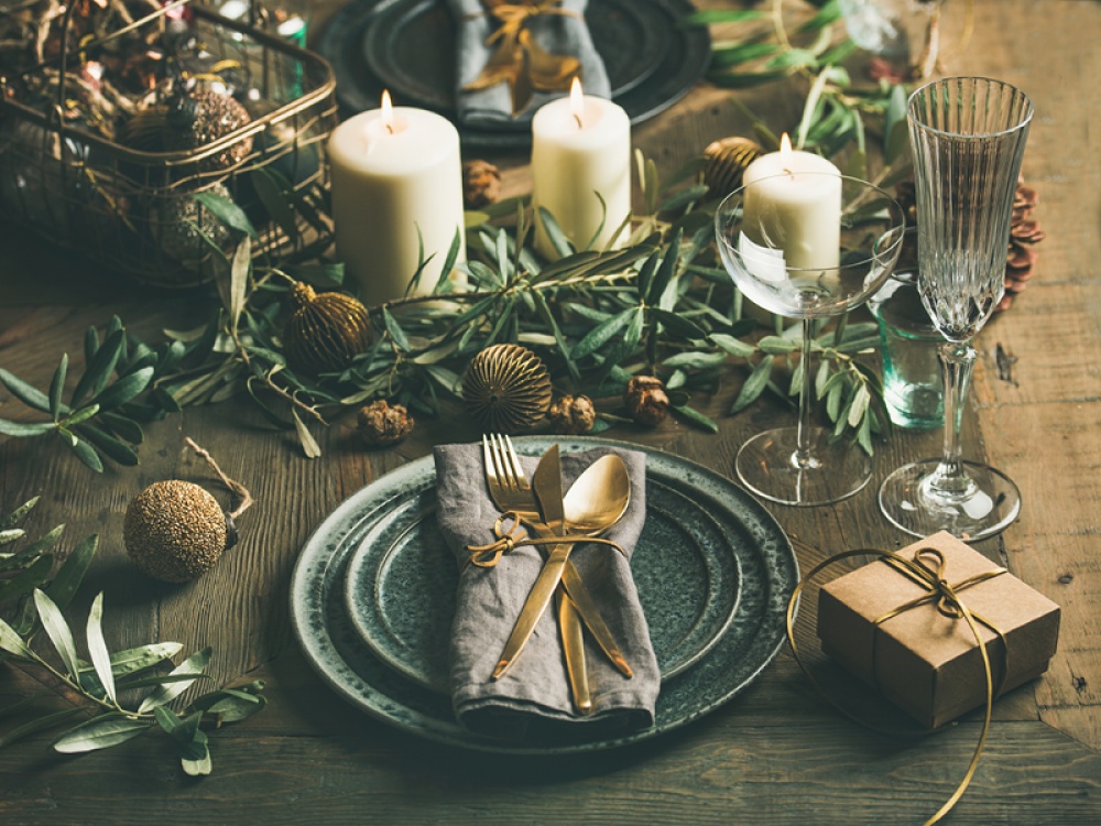 Christmas dinner table setting with green and gold tableware