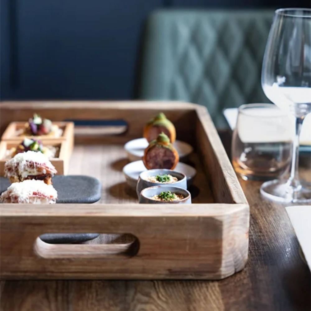 Food served on a wooden tray at Sonnet