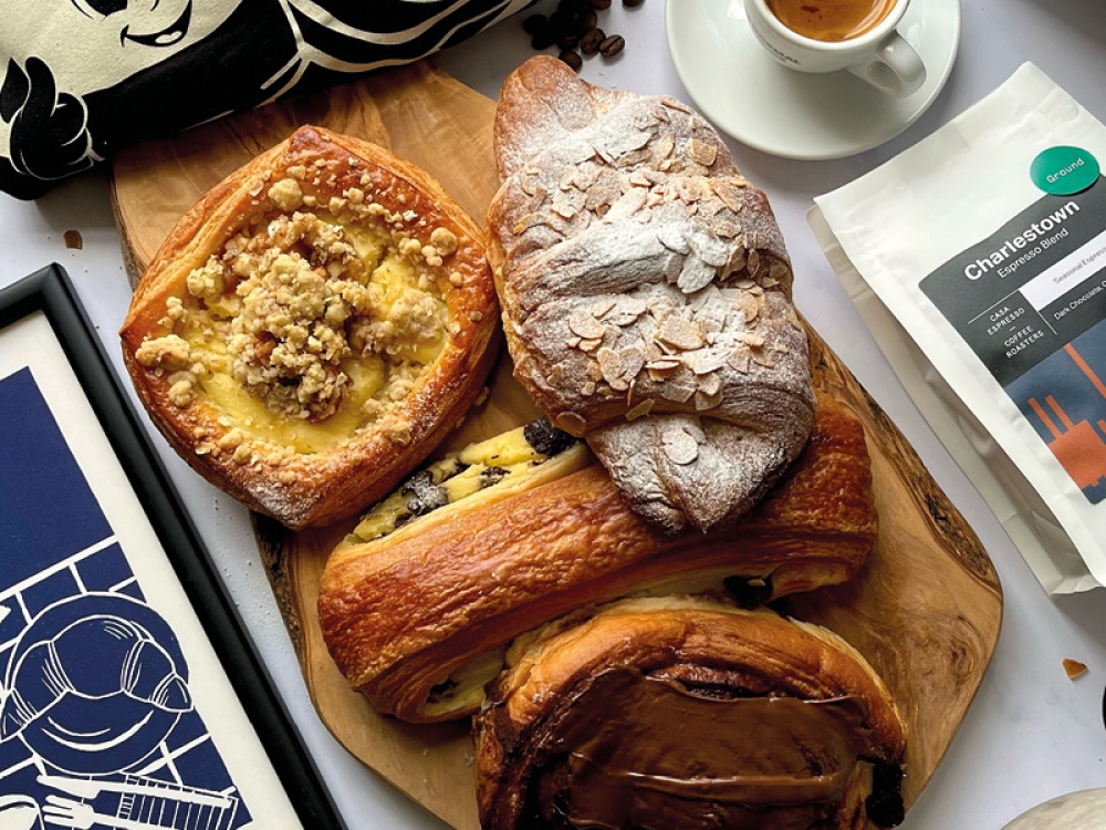 pastries on a wooden board with a fresh coffee