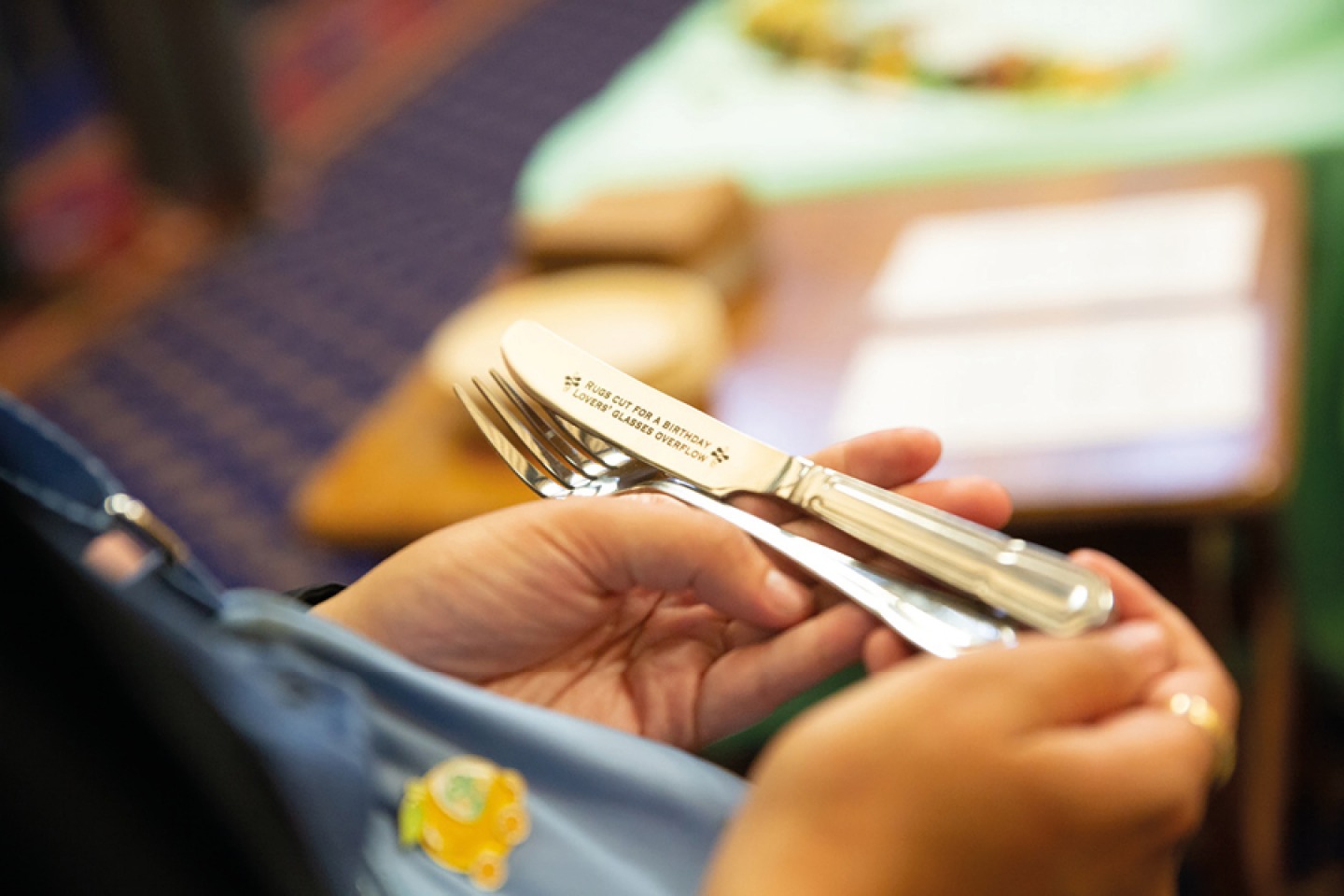 woman holding a engraved set of cutlery