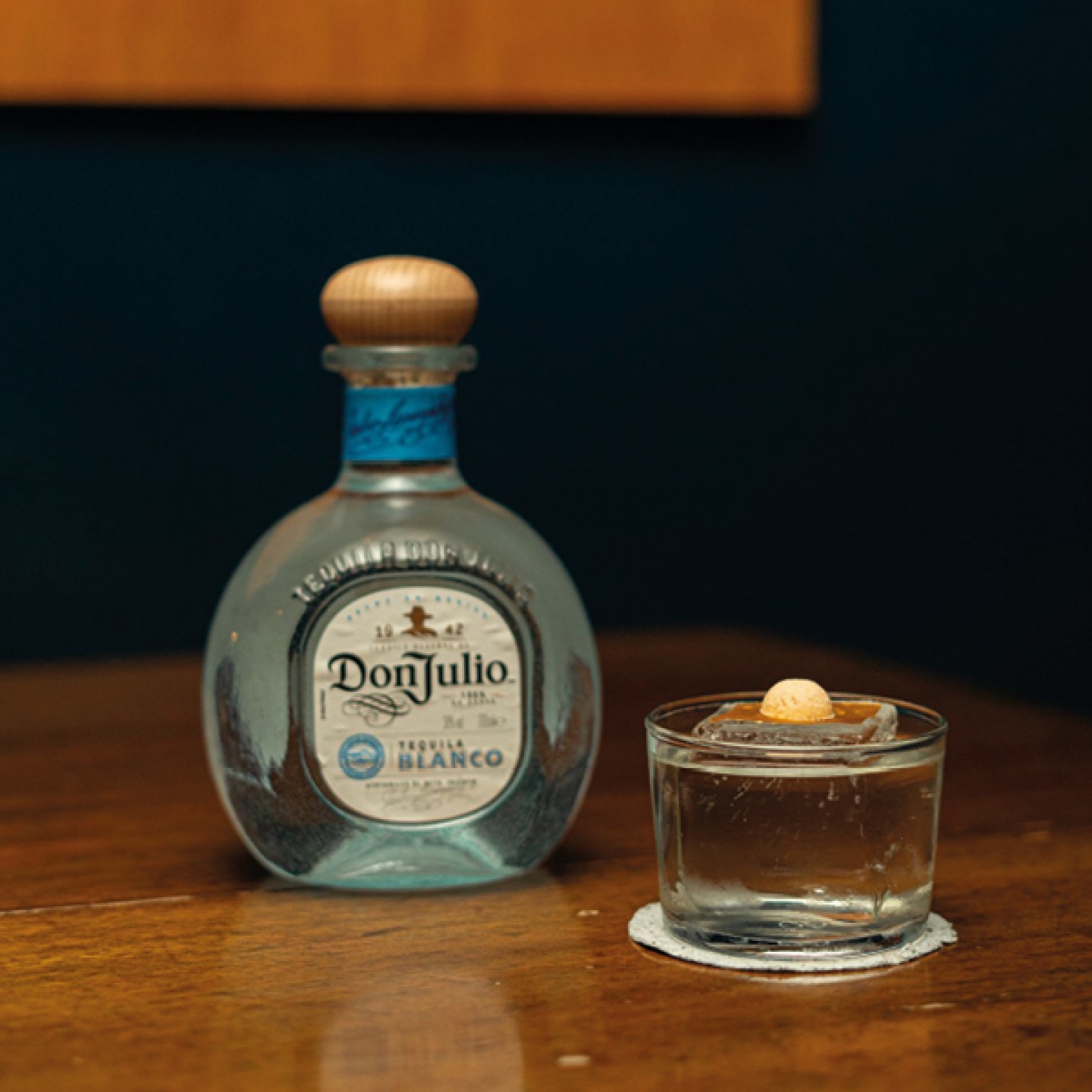 Bottle of DonJulio next to a cocktail
