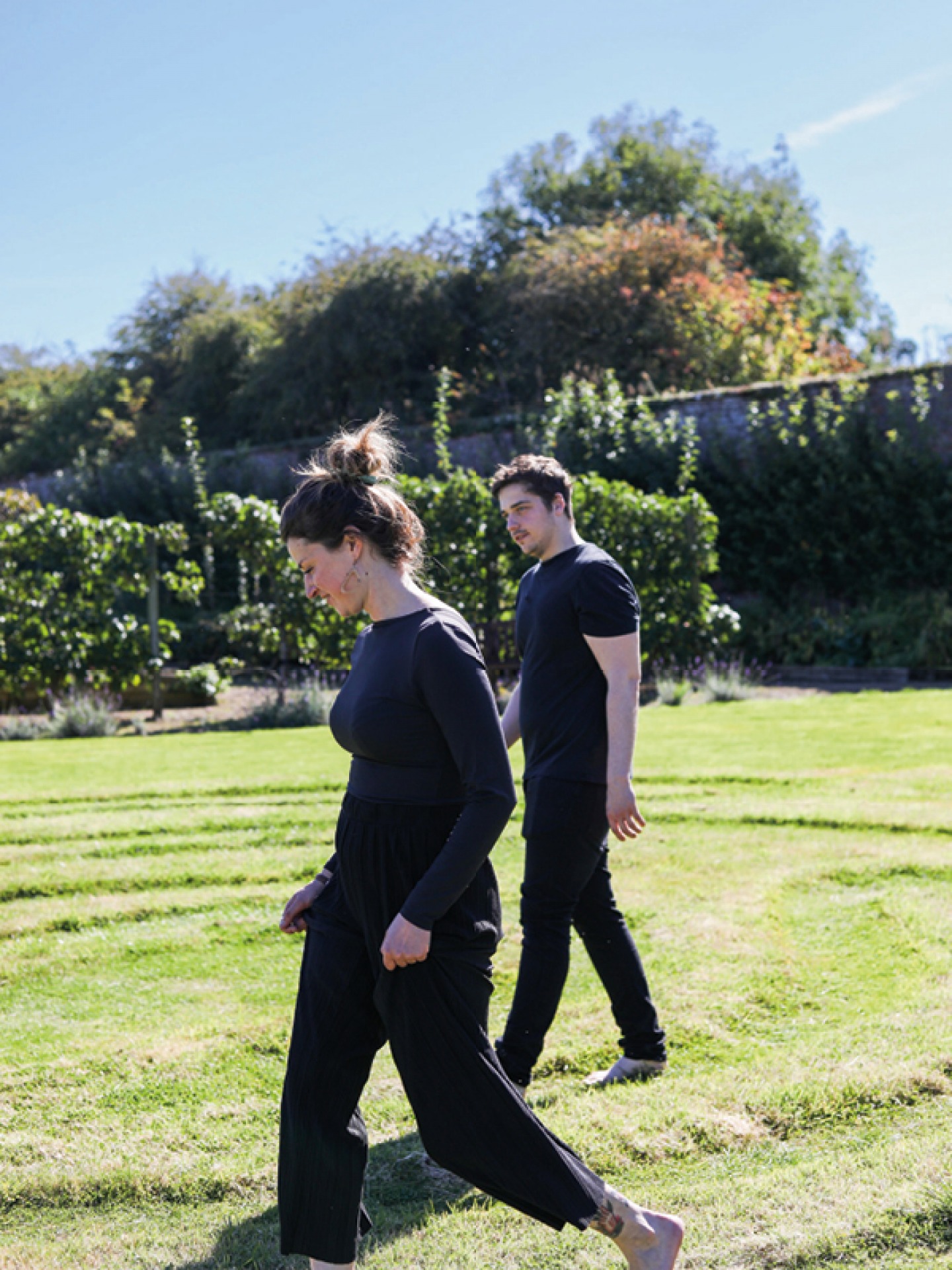 Tom and Laurissa Heywood walking barefoot in the gardens