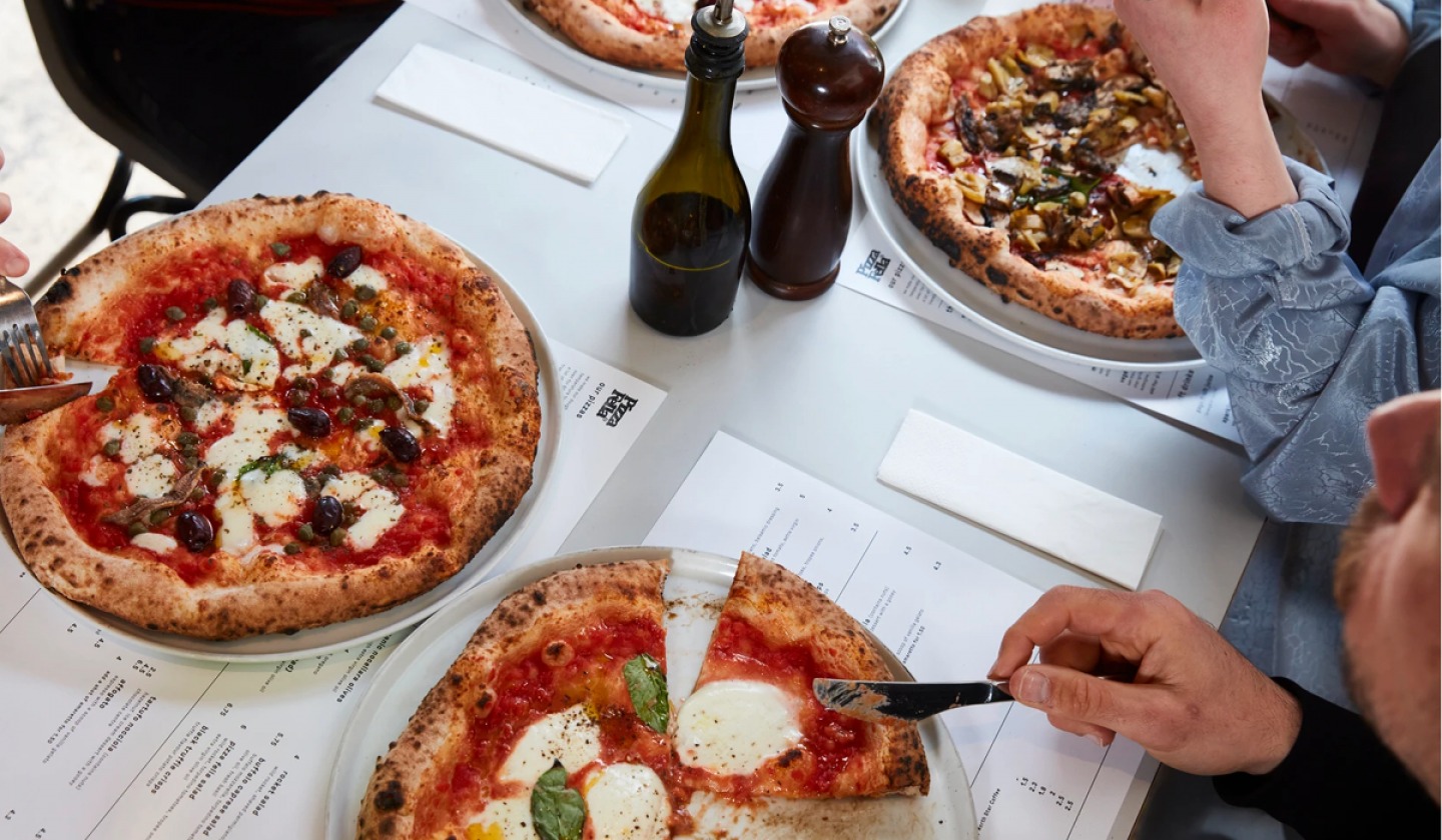 diners eating pizzas at Pizza Fella