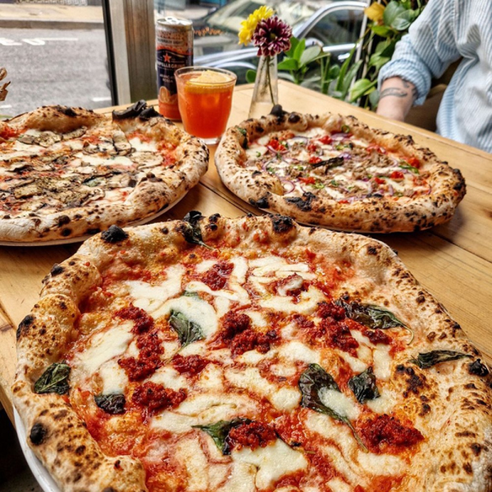 3 pizzas served on a table