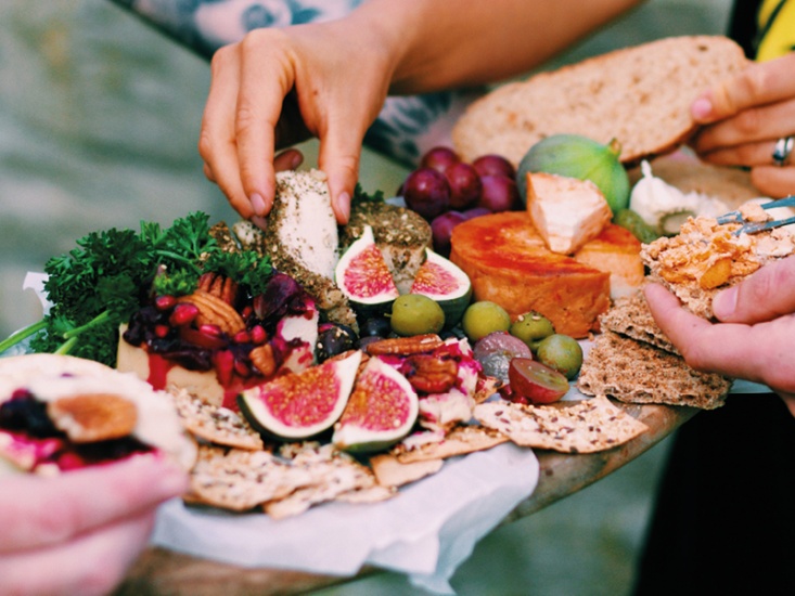 grazing board of cheese, fruits, nuts and olives