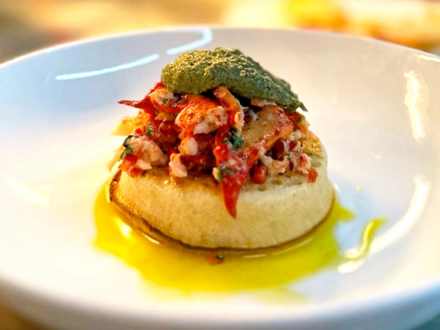 Shelfish on a crumpet topped with pesto