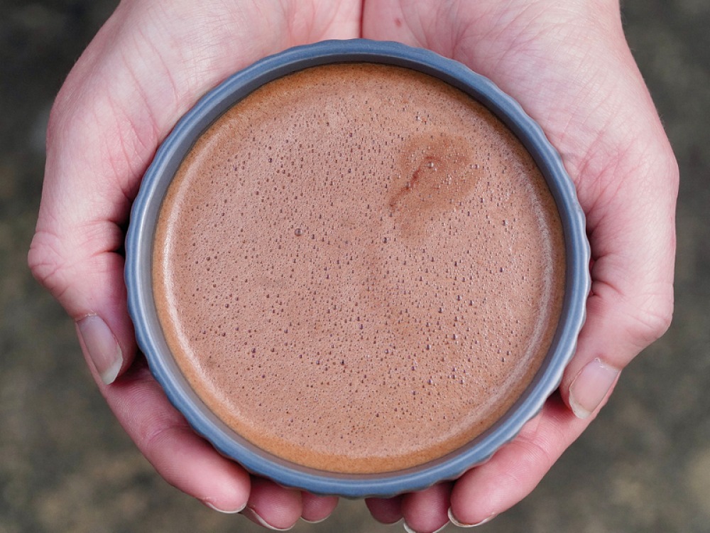 hands around a cup of hot chocolate