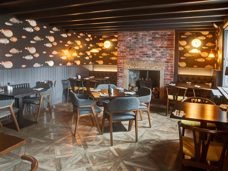 Lord Crewe Dining area, with wooden tables, cushioned chairs and low beamed ceiling