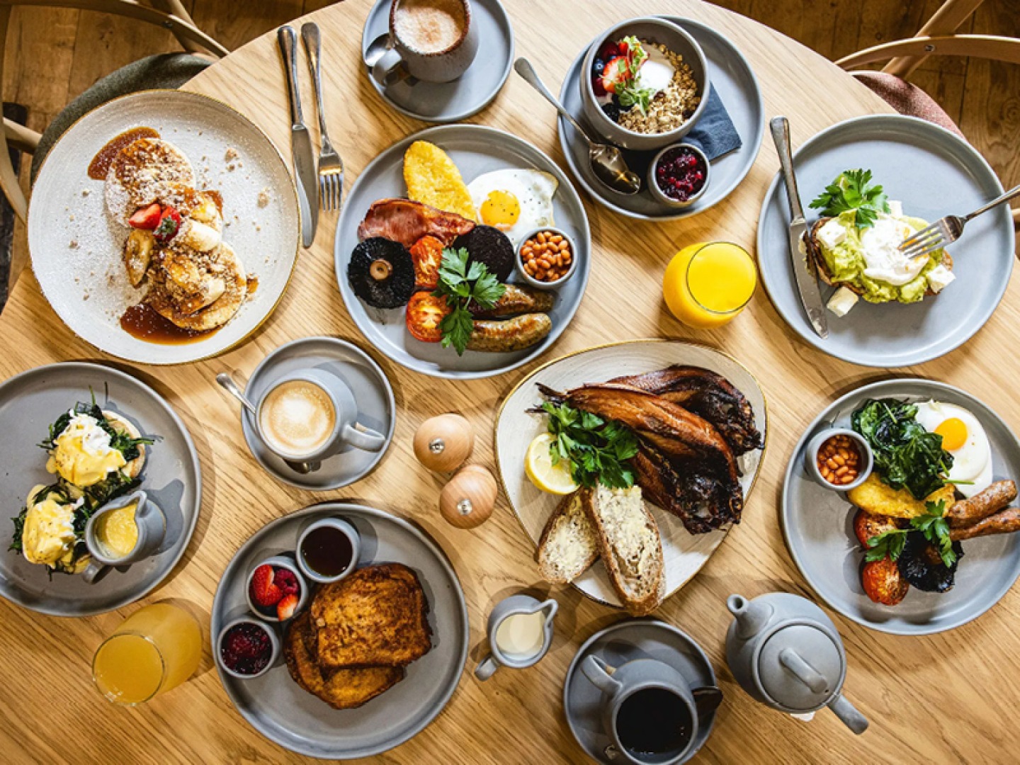 Ariel view of a table full of brunch dishes, coffees, teas and juices