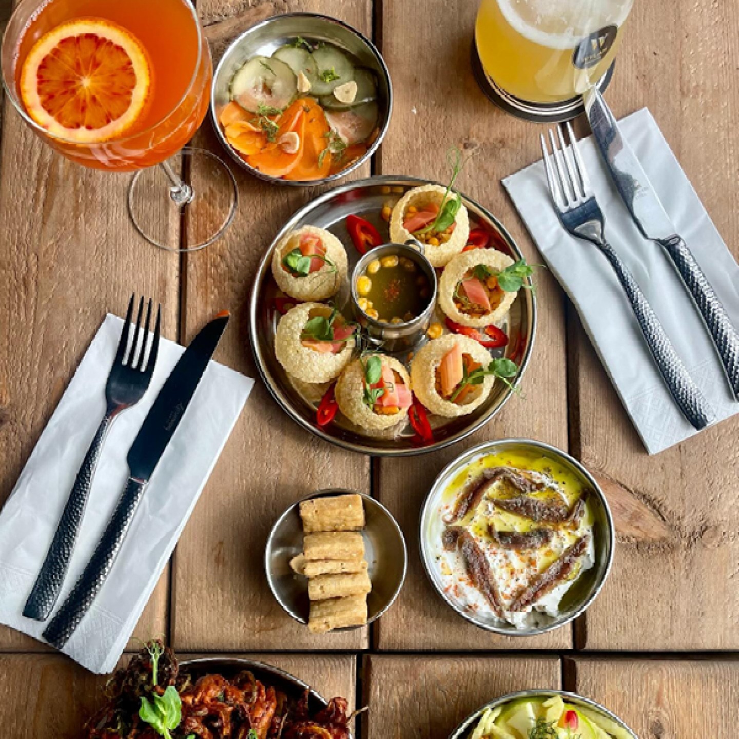 small Indian dishes with drinks and cutlery