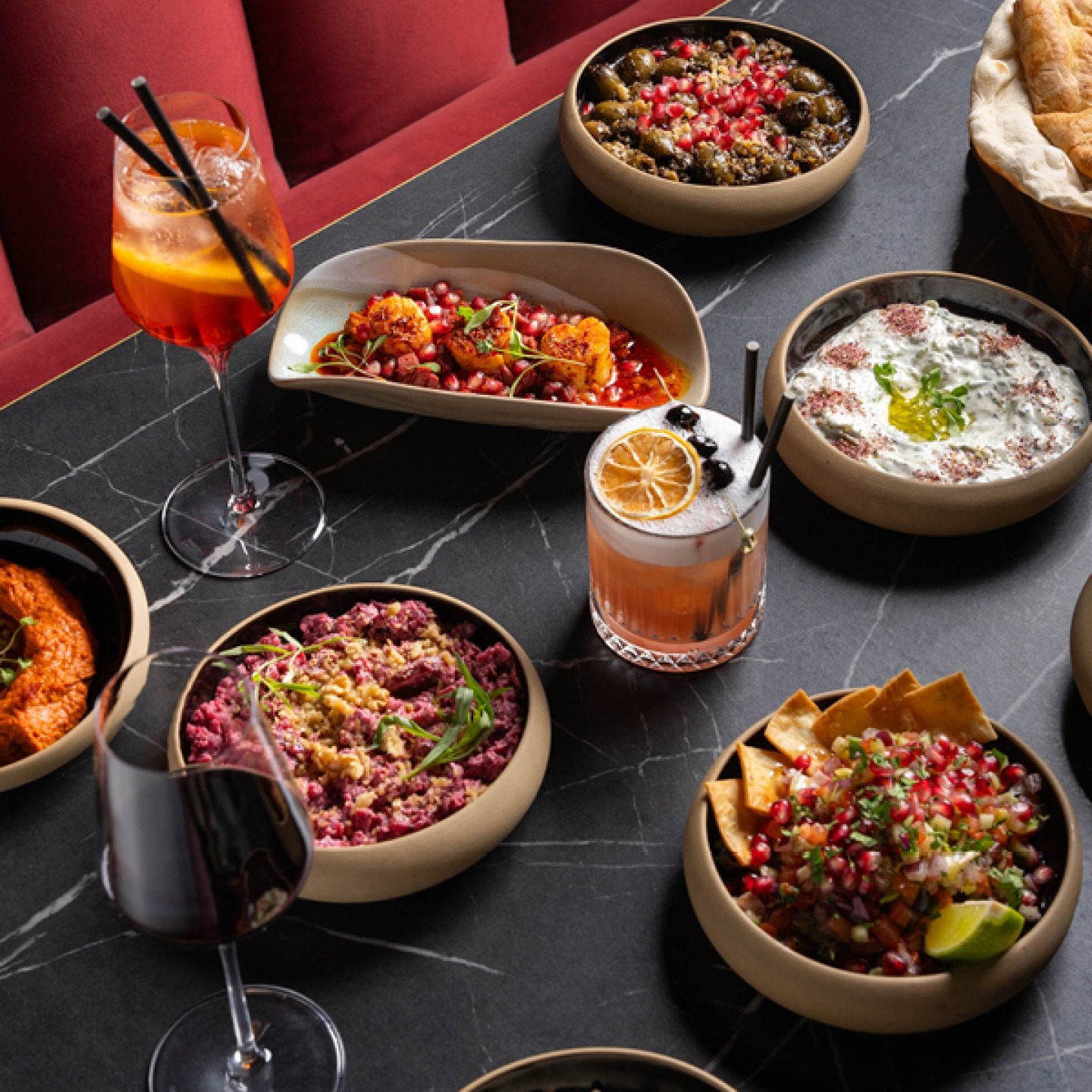 A selection of Middle Eastern dishes with cocktails and wine