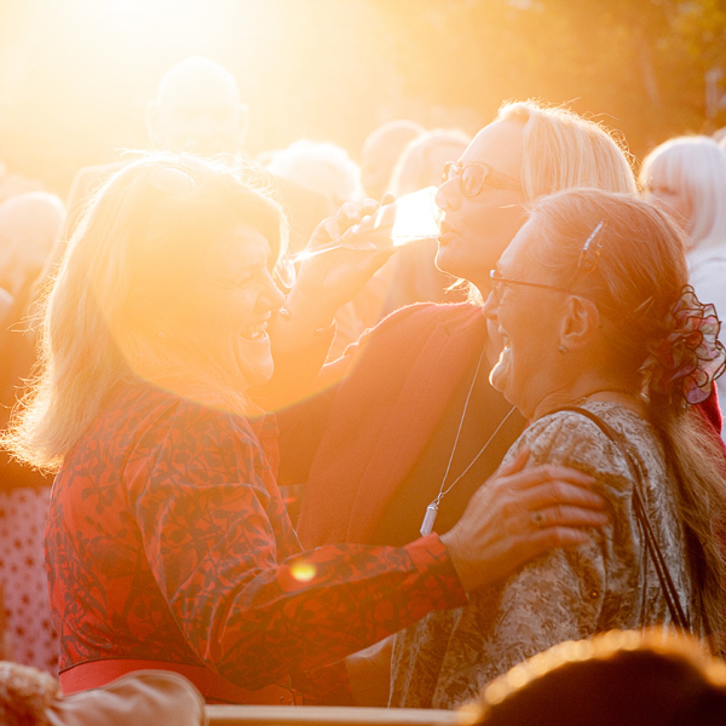 Ladies laughing and drinking in the sunshine