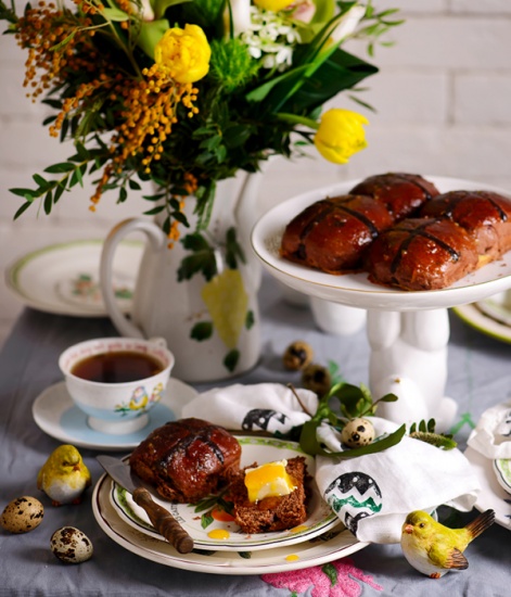 Easter themed table set with hot cross buns