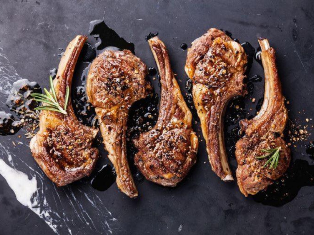 cooked lamb cutlets on a slate board