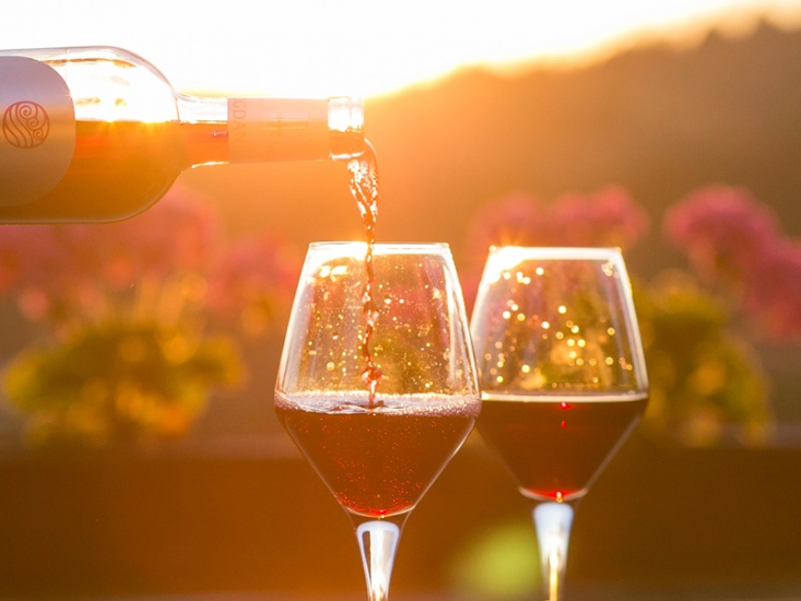 red wine poured at sunset, unsplash