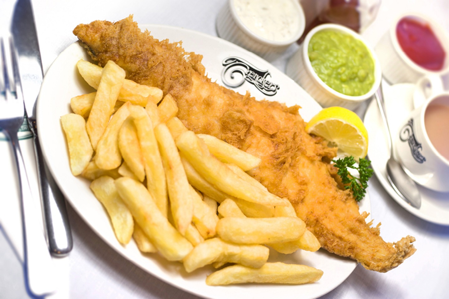 Fish and Chips with mushy peas, tartar sauce and ketchup