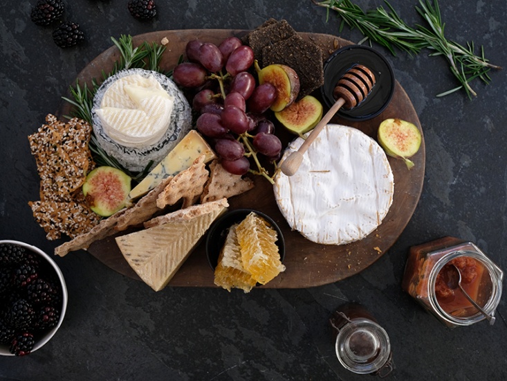 Cheese board with fruit honey and chutneys