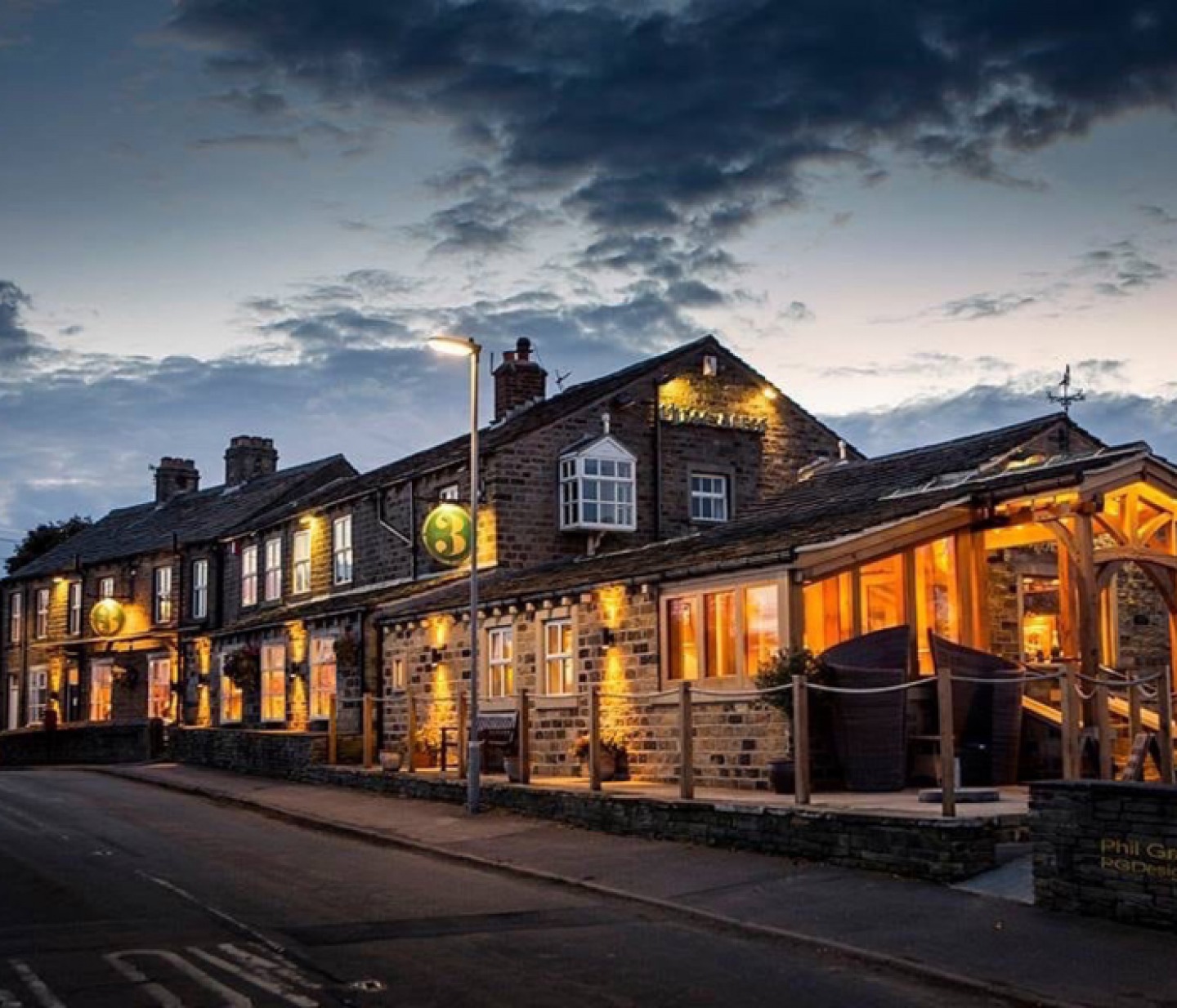 a traditional looking English pub lit up at night