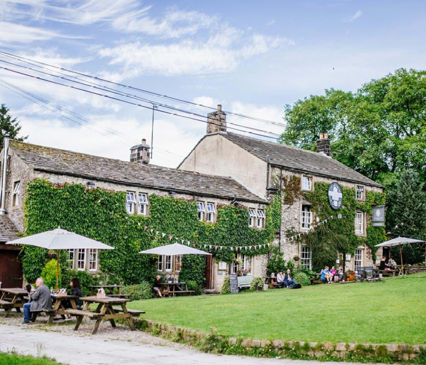 an English pub covered in green ivy on a summers day