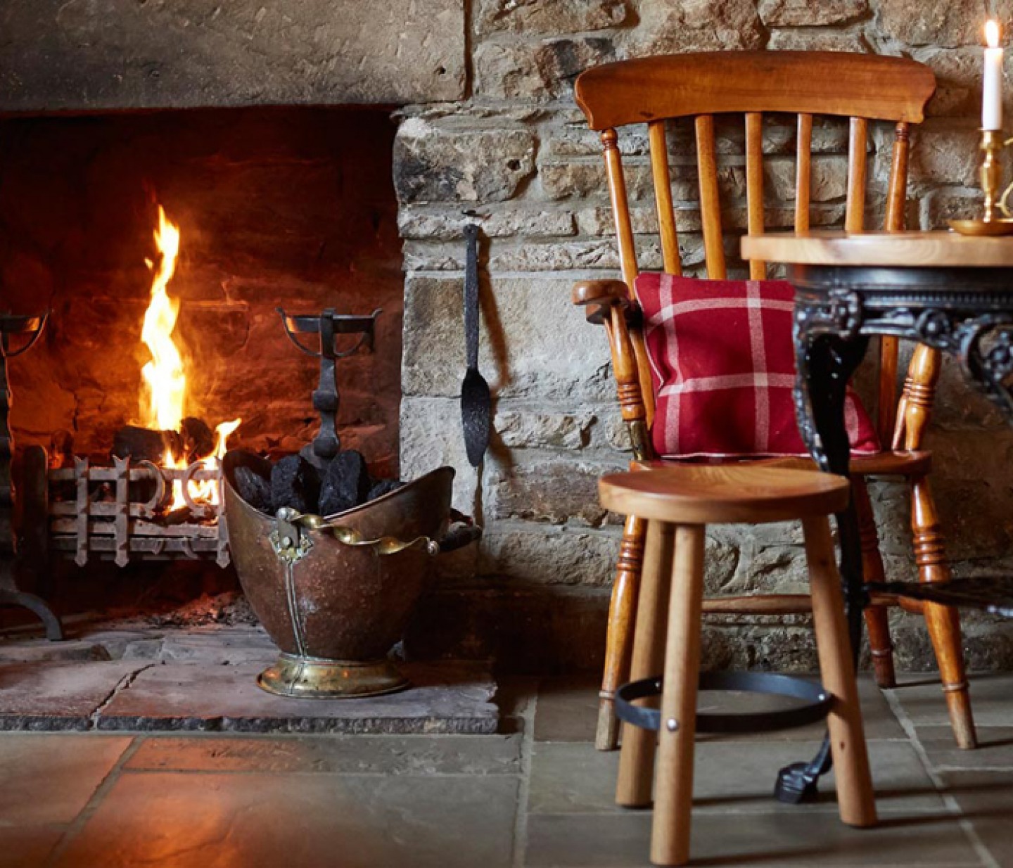 an open fire in a stone brick pub