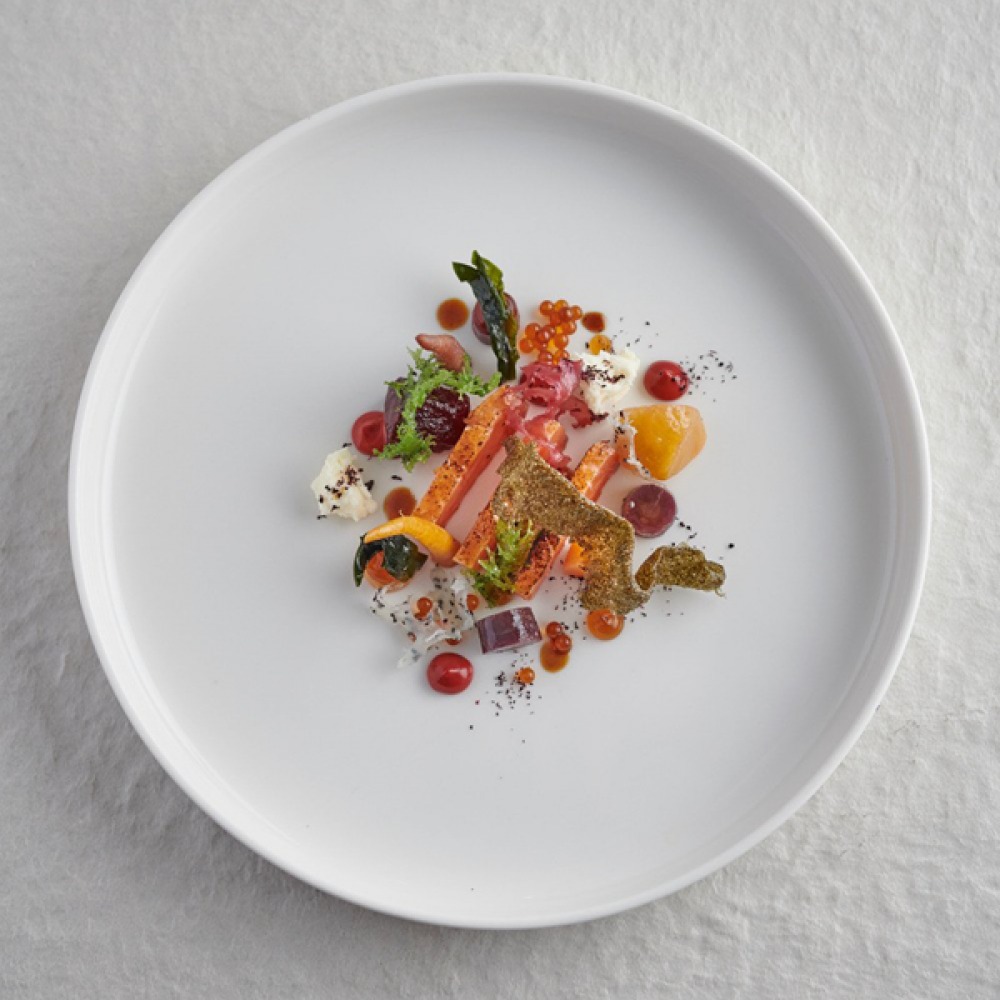 hay smoked trout on a white plate