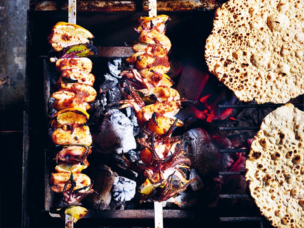 Tandoori Grilled Calamari over a grill with flat breads