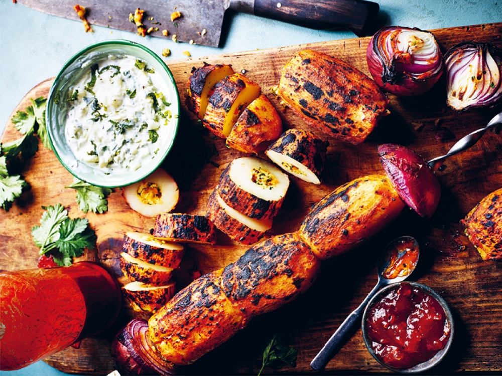 Stuffed Potatoes on a board with onions and dips