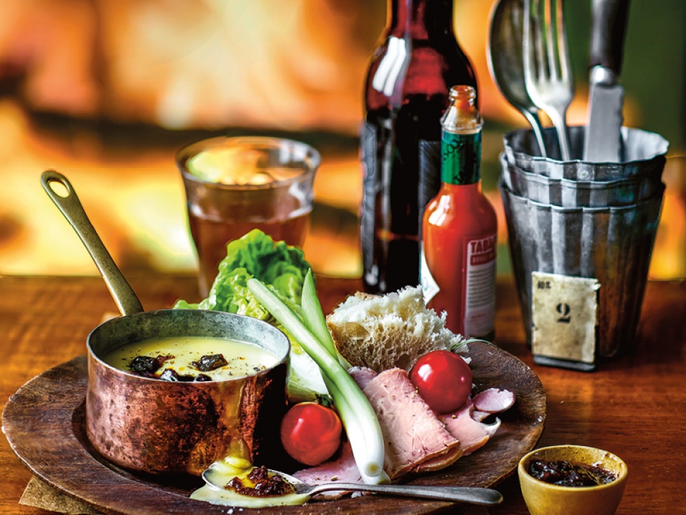 plate of food with cheese, ham, tomatoes and chutney