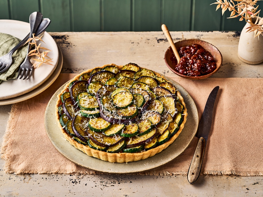 Hummus, Courgette and Aubergine Easter Tart on a wooden table
