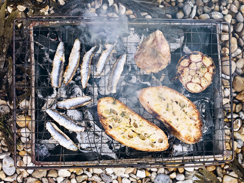 anchovies, bread and garlic over a barbecue
