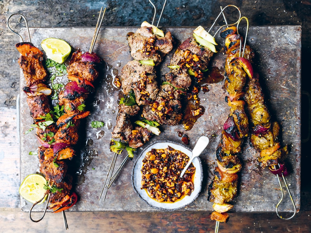 barbecued kebabs on a stone plate