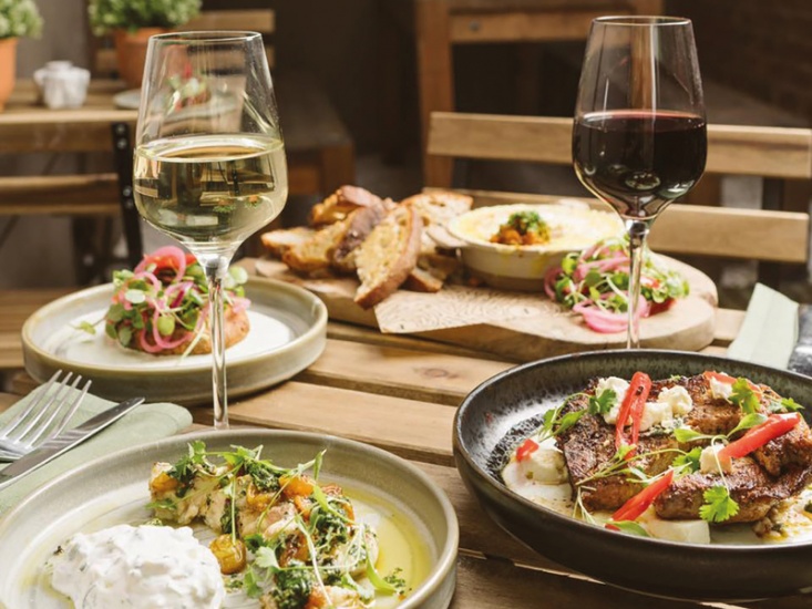Meals and wine set on table at Forge, York