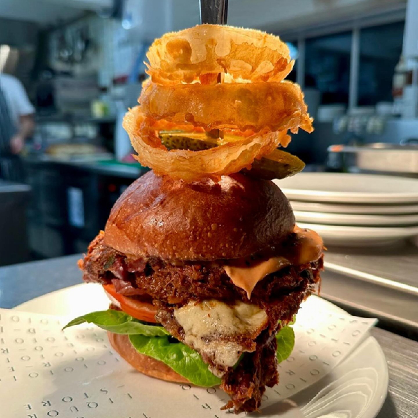Burger stacked with onion rings