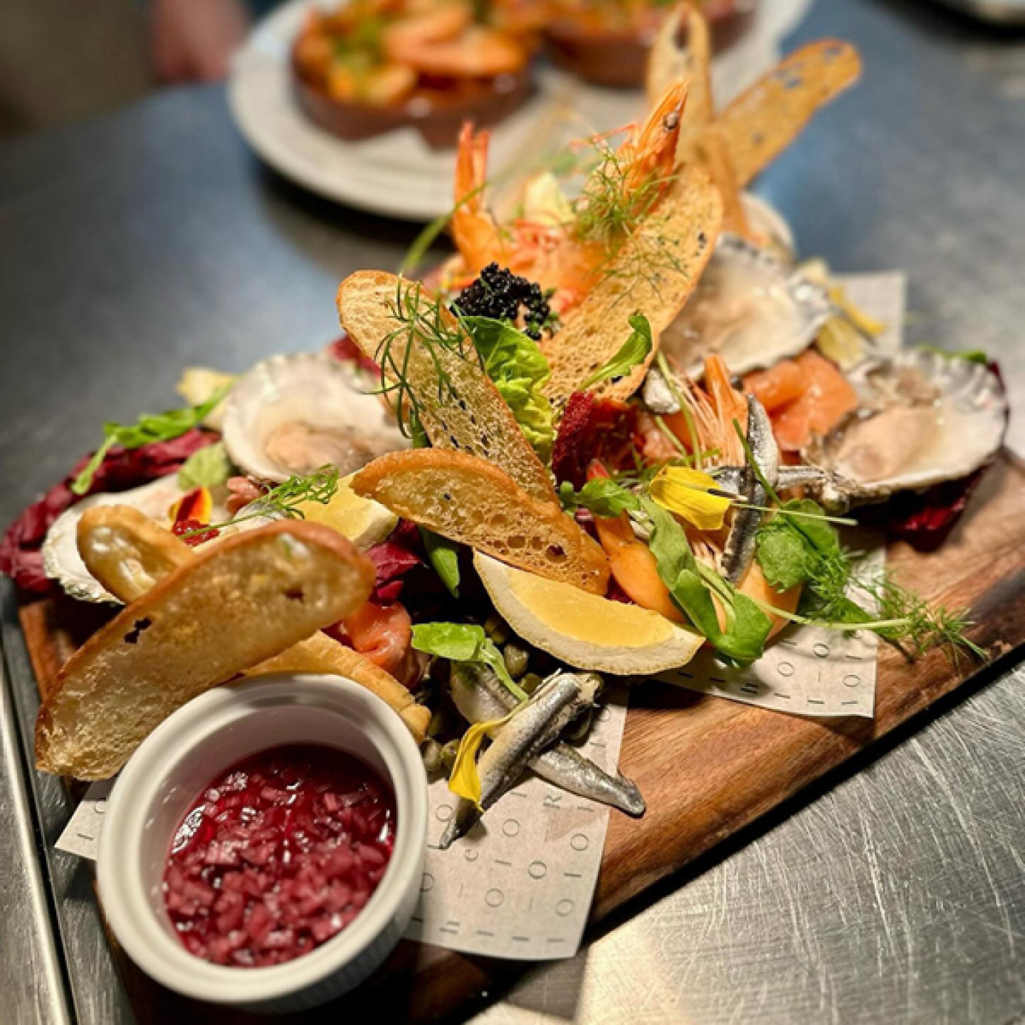 Seafood sharing board with bread and dips