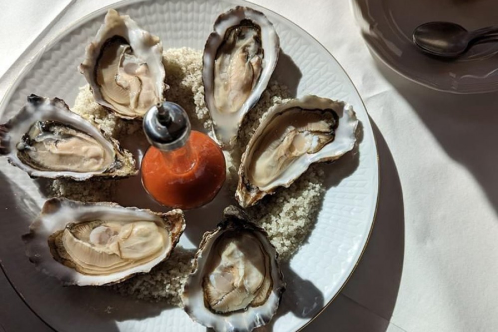 Oysters with a glass bottled sauce