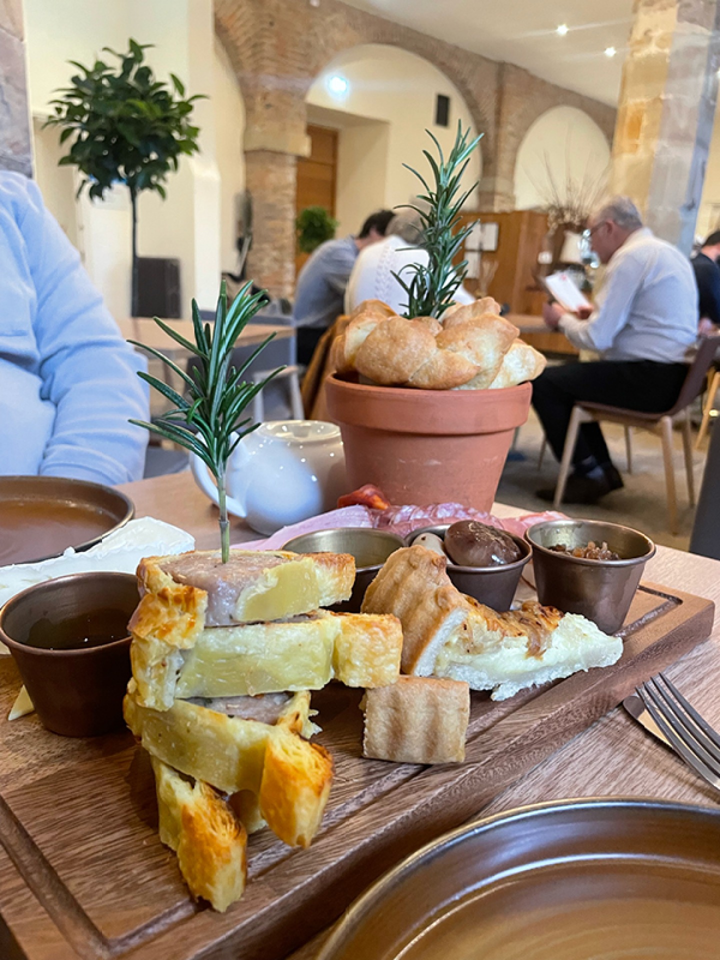 Board of savoury food garnished with fresh Rosemary